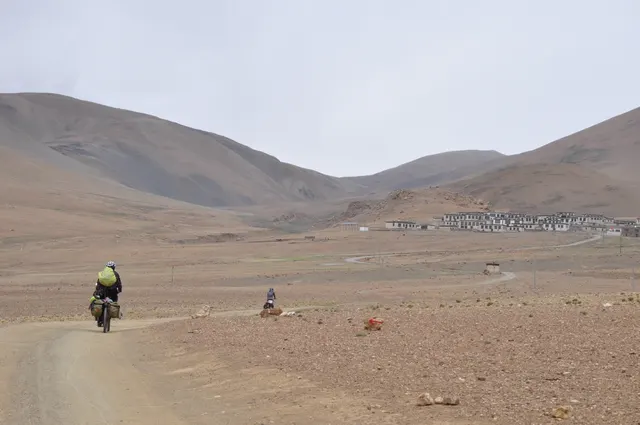 Winding road descending through green Himalayan foothills into Nepal